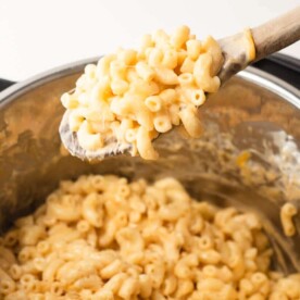 mac and cheese being scooped out of an instant pot