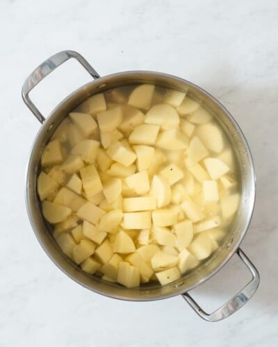 a large stainless pot of chopped potatoes to boil