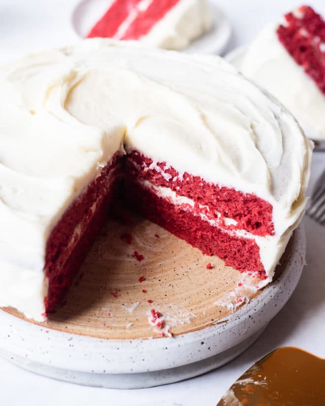 a red velvet cake with a slice cut out of it