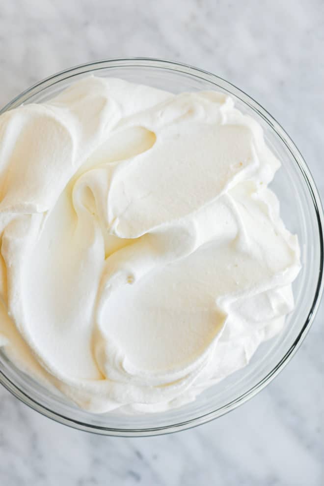 a large glass bowl of honey sweetened whipped cream