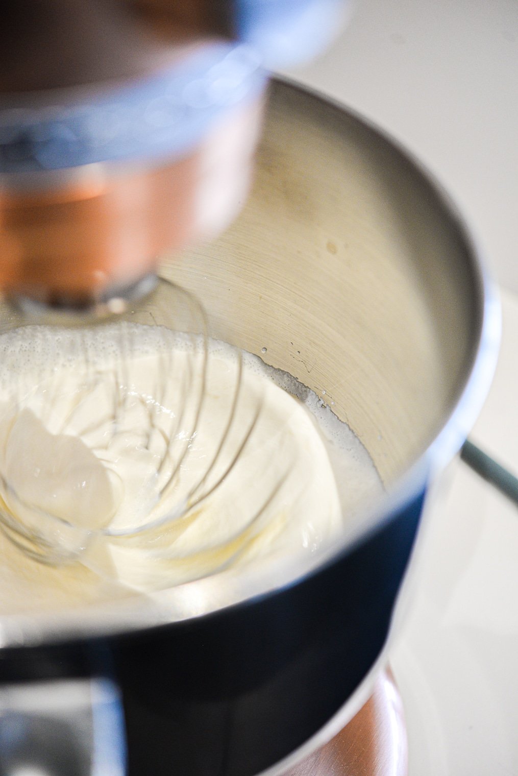 honey sweetened whipped cream being made in a stand mixer