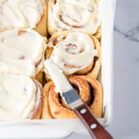 cinnamon rolls that have been iced in a baking dish