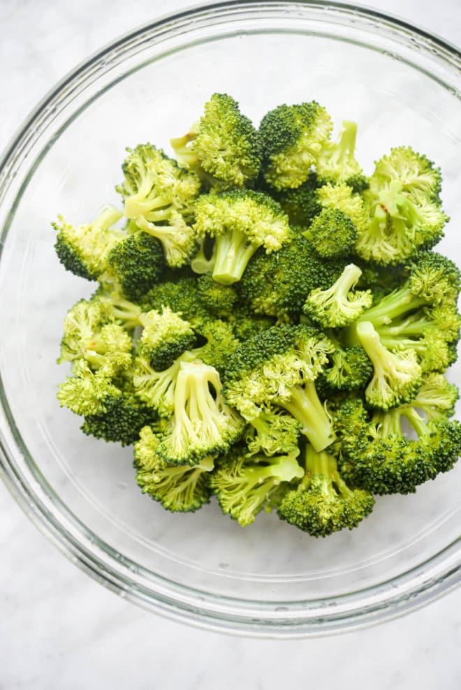 a glass bowl of broccoli florets