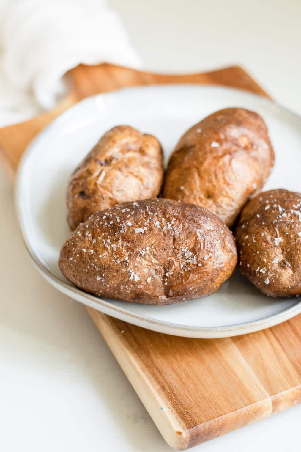 4 salted, air fried baked potatoes on a plate