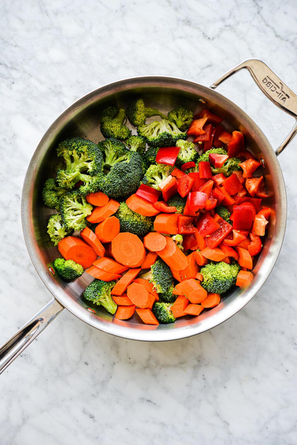 the veggies for chicken stir fry in a large stainless steel skillet