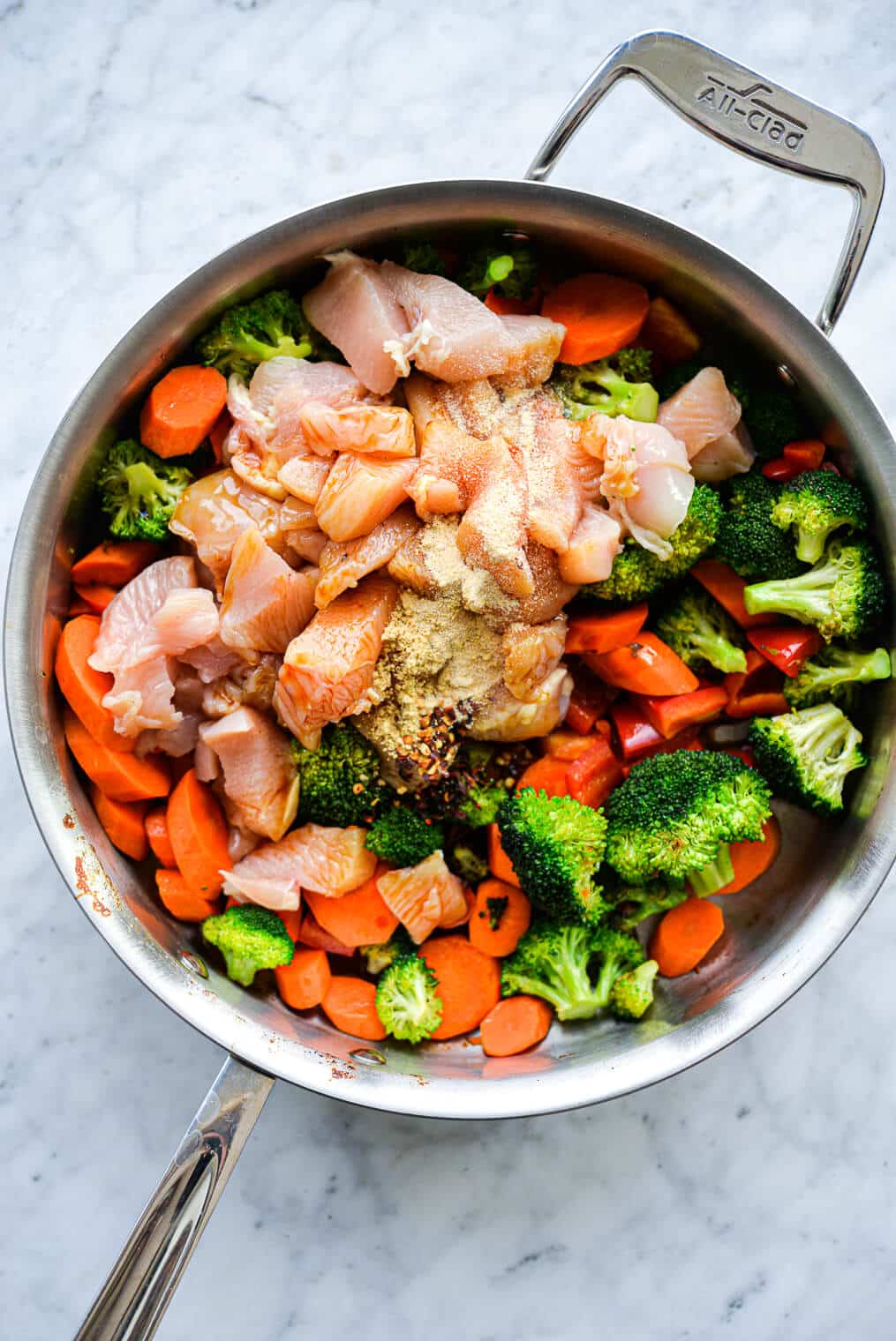 the ingredients for chicken stir fry in a large stainless steel skillet