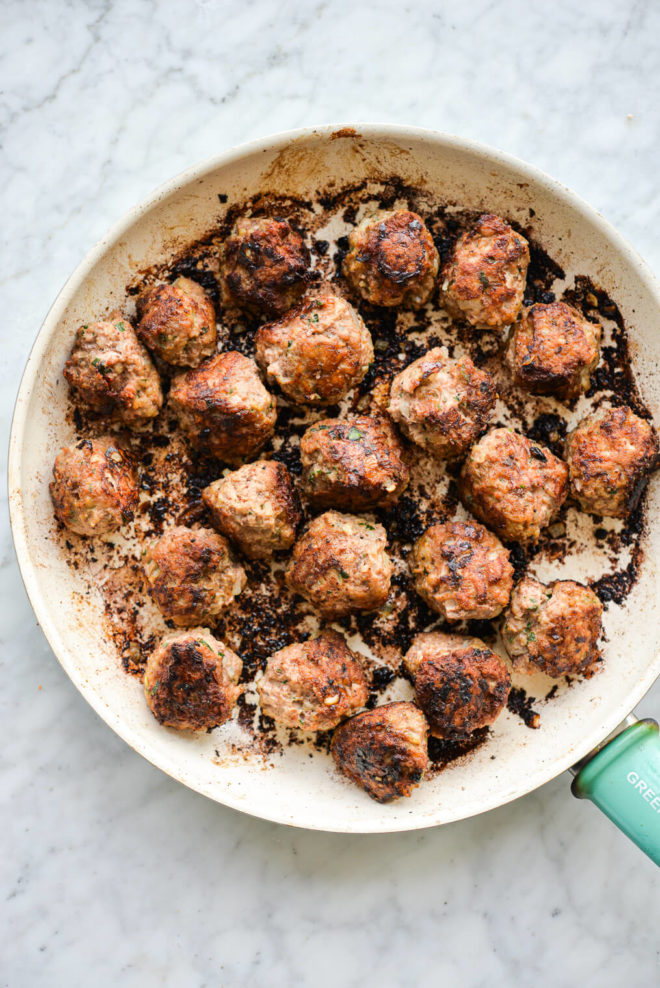 turkey meatballs searing in a skillet