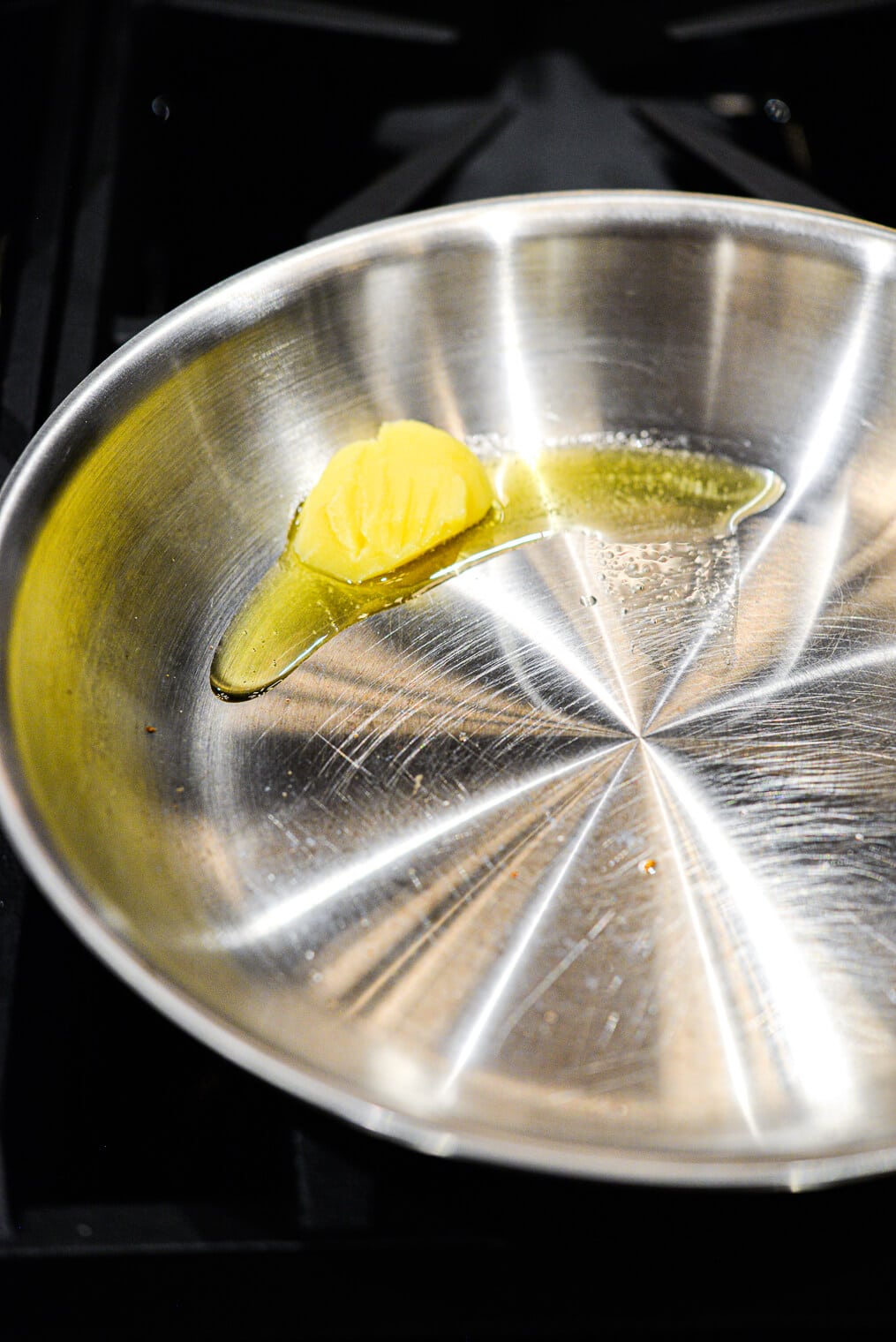 Butter melting in stainless steel pan
