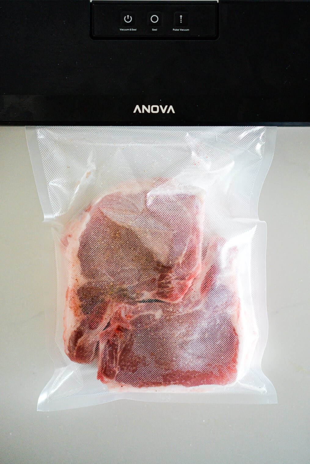 Two bone-in pork chops in a sous vide bag.