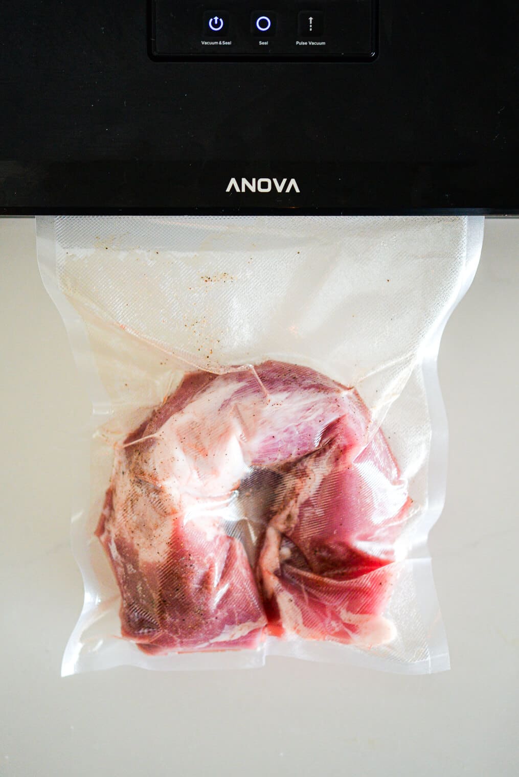 Raw pork tenderloin in vacuum sealed bag.