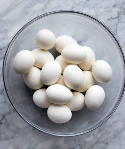 Glass bowl with hard boiled, white eggs.