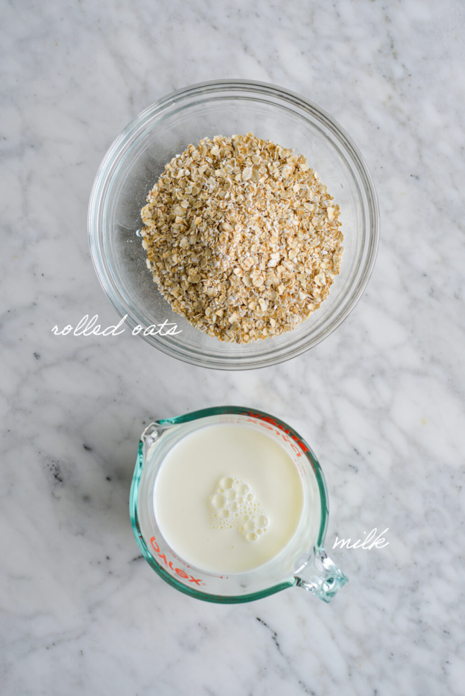 Top down shot of oat milk ingredients with ingredient labels written out in white, cursive letters.