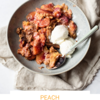 Bowl of peach dump cake in a bowl topped with vanilla ice cream with a spoon on a linen towel with the words "Peach Dump Cake" and Fed+Fit written below.