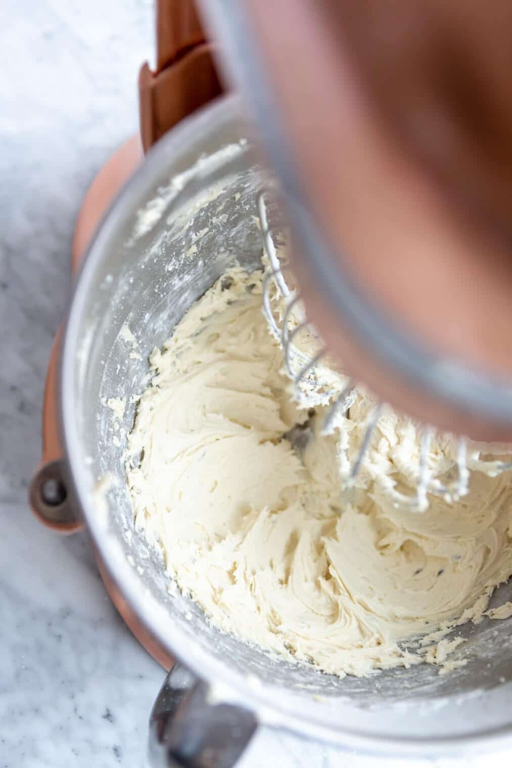 Lavender buttercream in a stand mixer with whisk attachment.