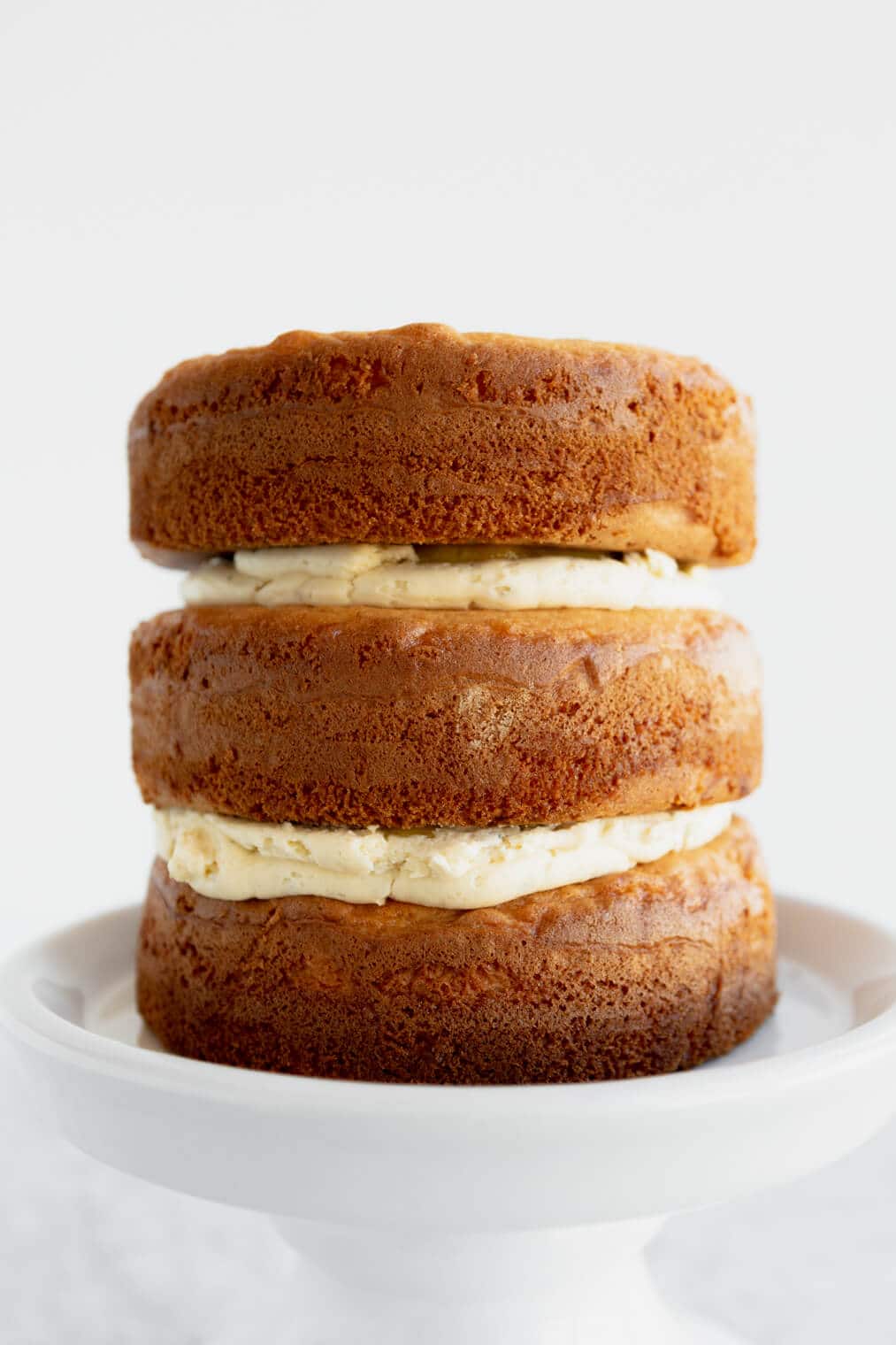 Three layers of lemon lavender cake stacked on top of one another.