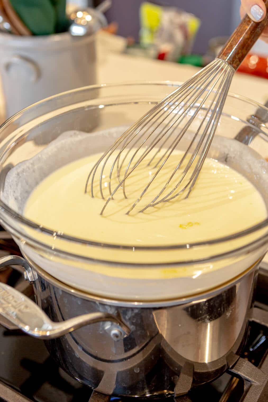 Wet ingredients whisked together in a large glass bowl over a double boiler.