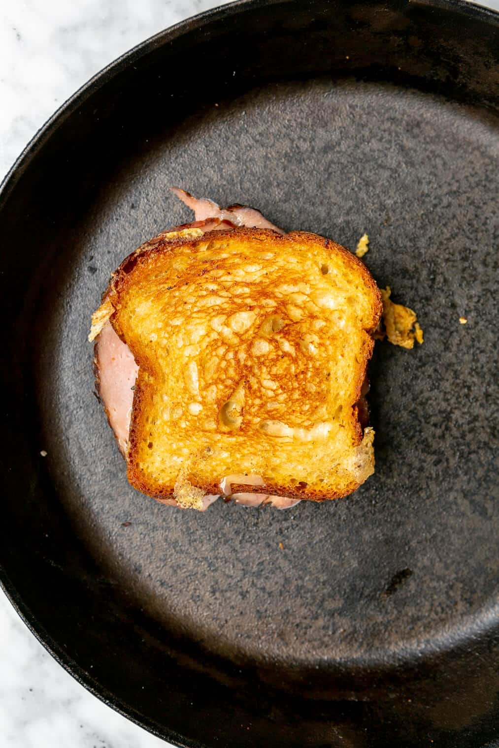 Grilled cheese sandwich in a cast iron skillet.