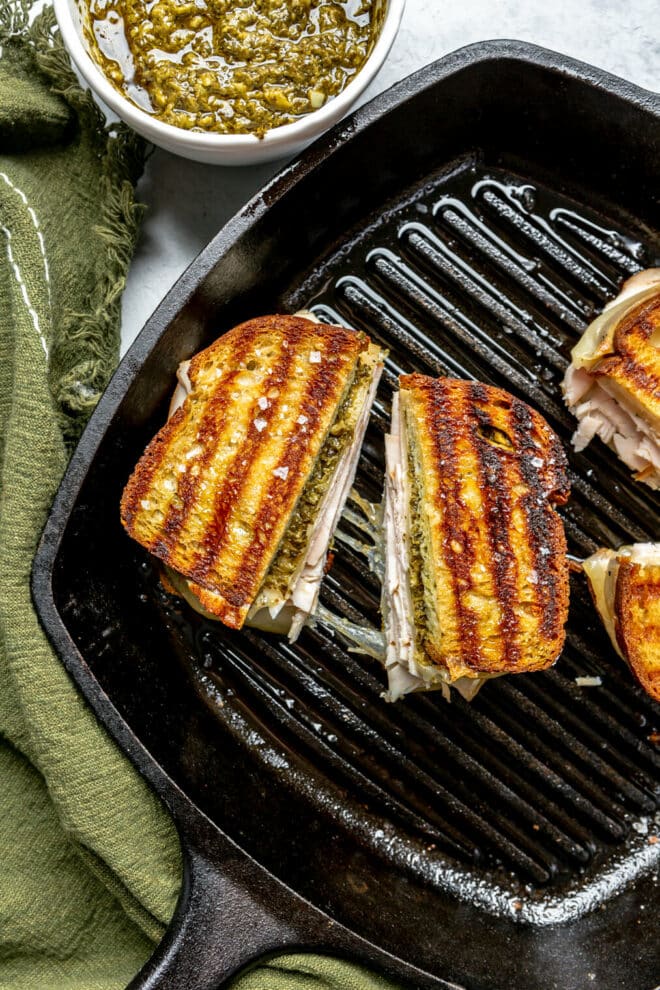 Grilled cheese sandwich with grill marks in a cast iron grill pan.