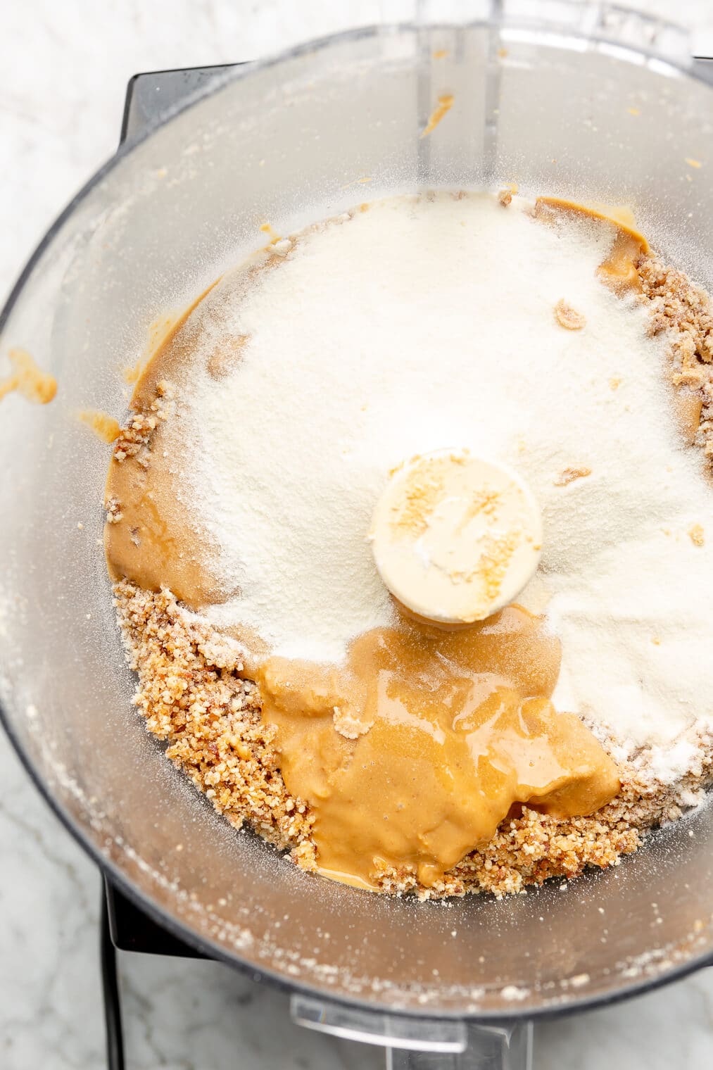 Peanut butter and collagen peptides in a food processor blender.