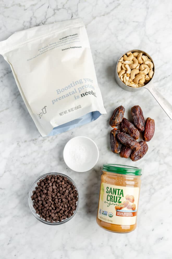 Ingredients for peanut butter energy balls on a grey and white marble surface.