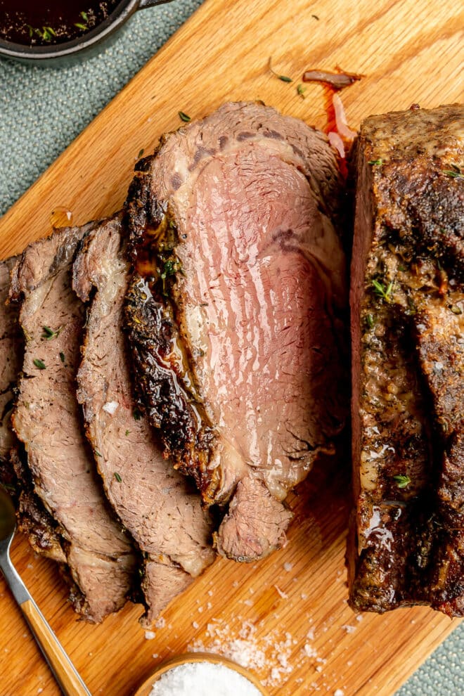 Sliced prime rib roast on a cutting board.