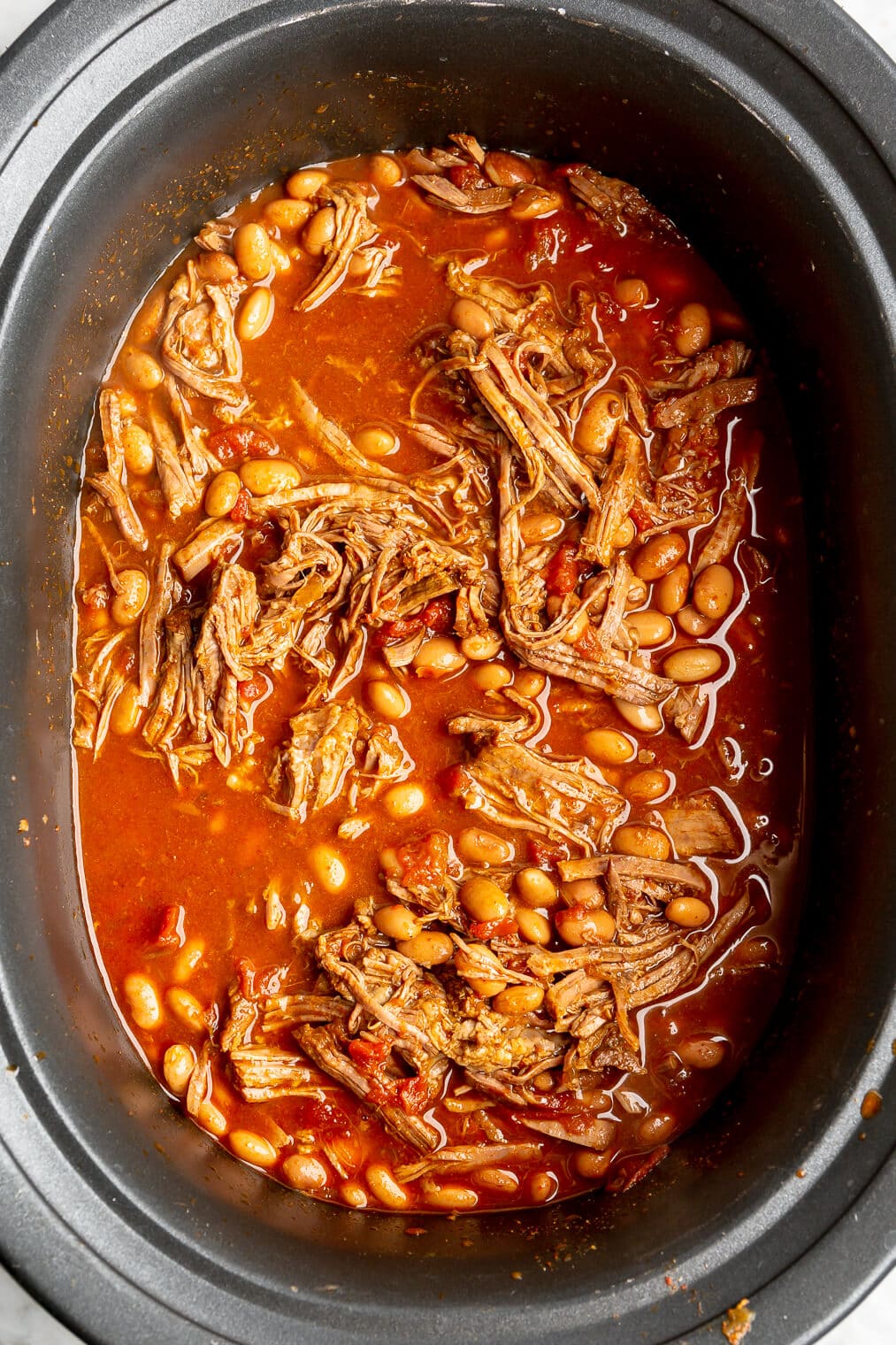 Shredded beef and bean chili in a crockpot.