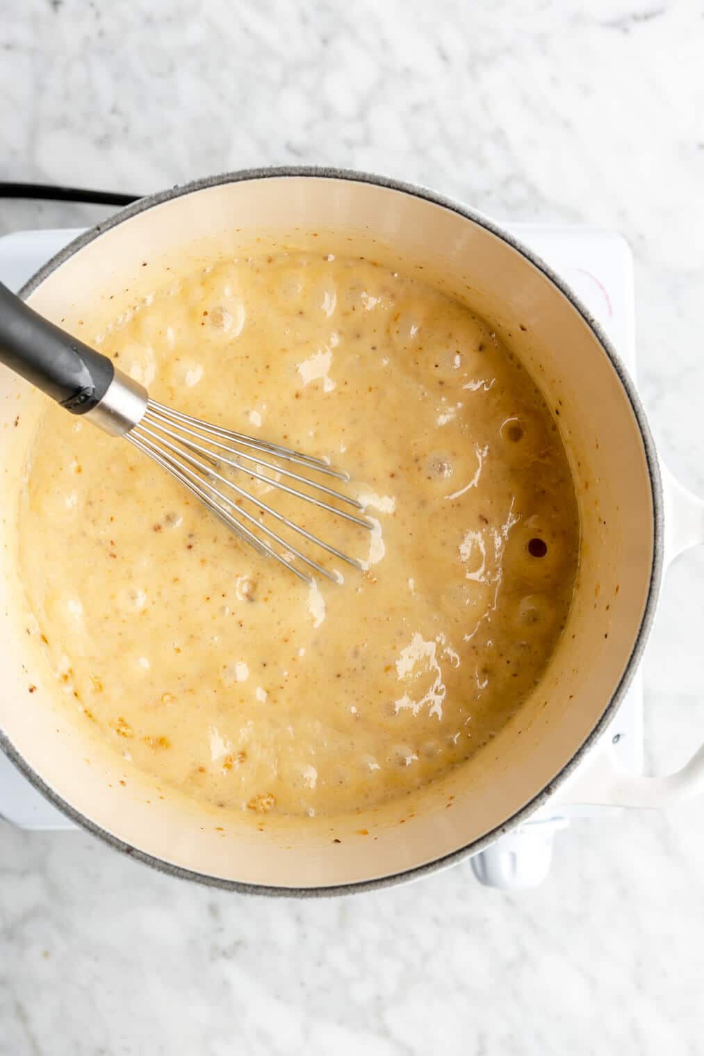 Butter and condensed milk bubbling in a sauce pan.