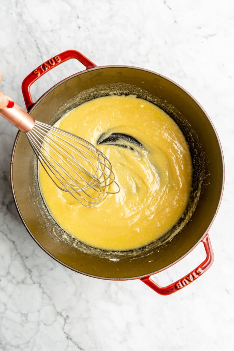 Whisk with butter and flour in a large dutch oven forming a roux.