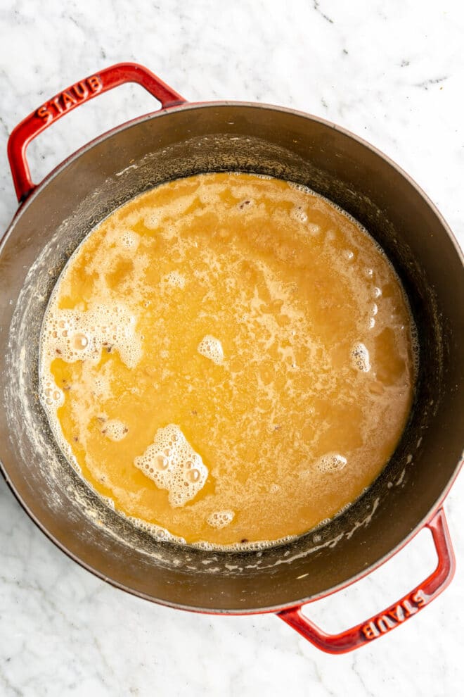 A roux that has been cooked to a caramel, peanut butter color in a large dutch oven.