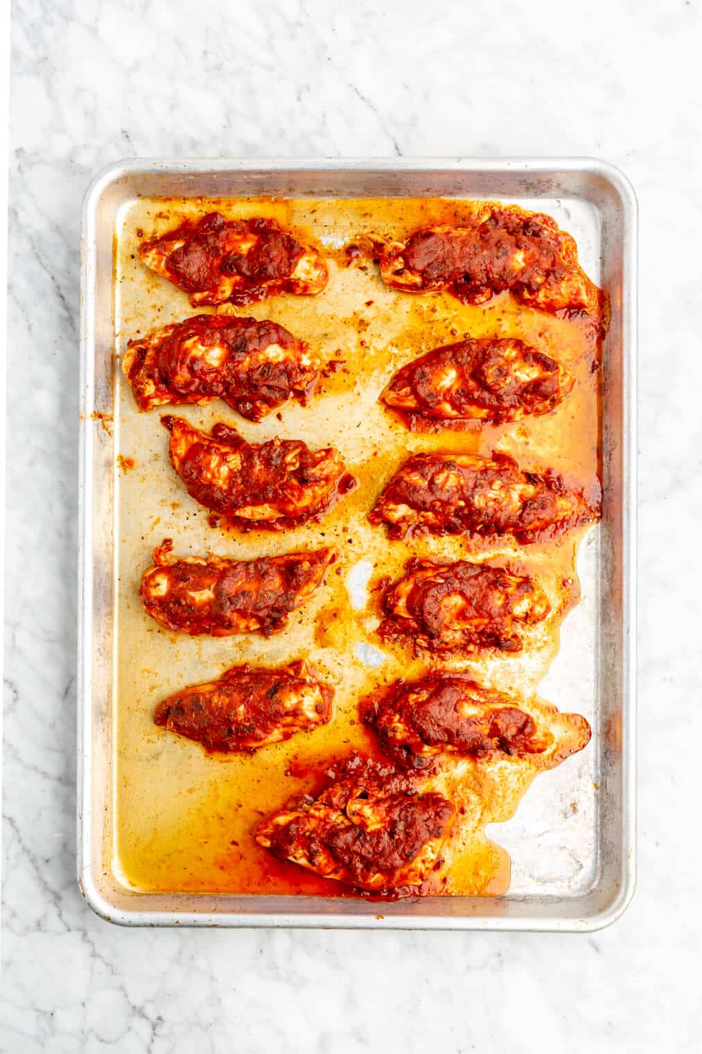Chicken baked on a sheet pan.