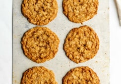 Sheet pan with 6, large oatmeal cookies on the pan.