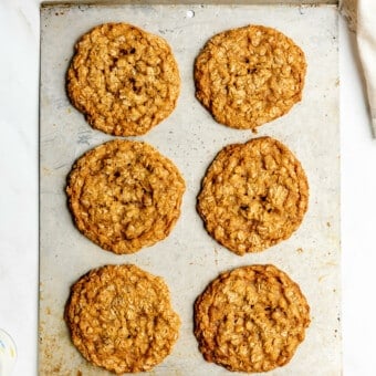 Sheet pan with 6, large oatmeal cookies on the pan.