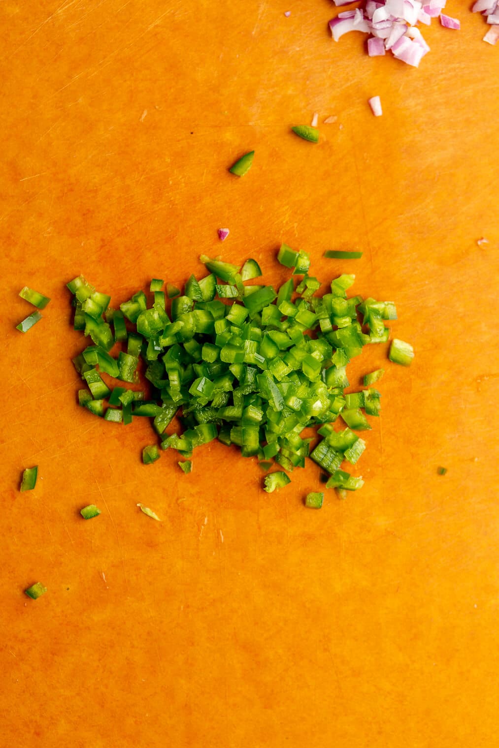 Diced jalapeno on a cutting board.