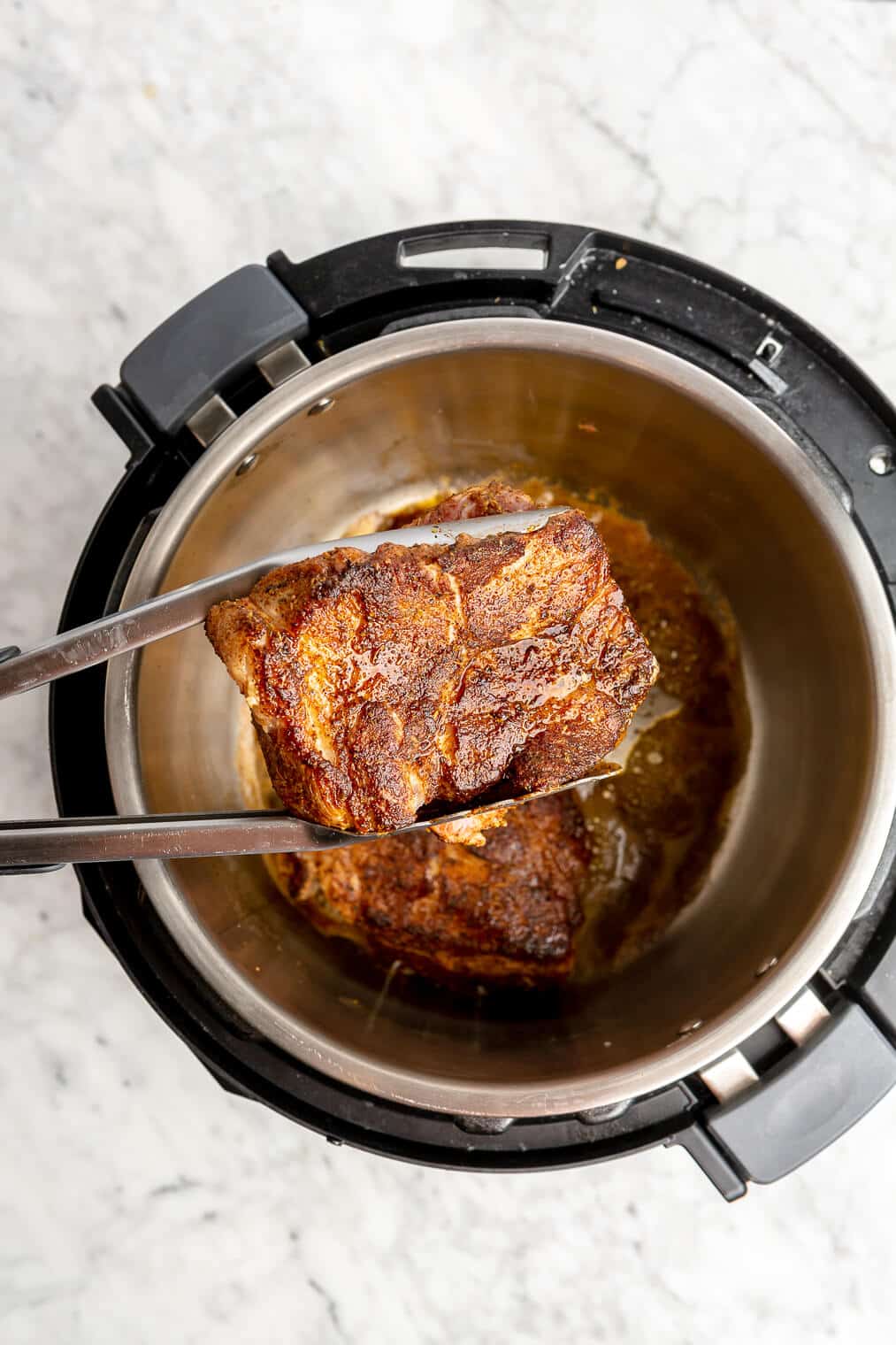 Pork shoulder that has been seared in an instant pot.