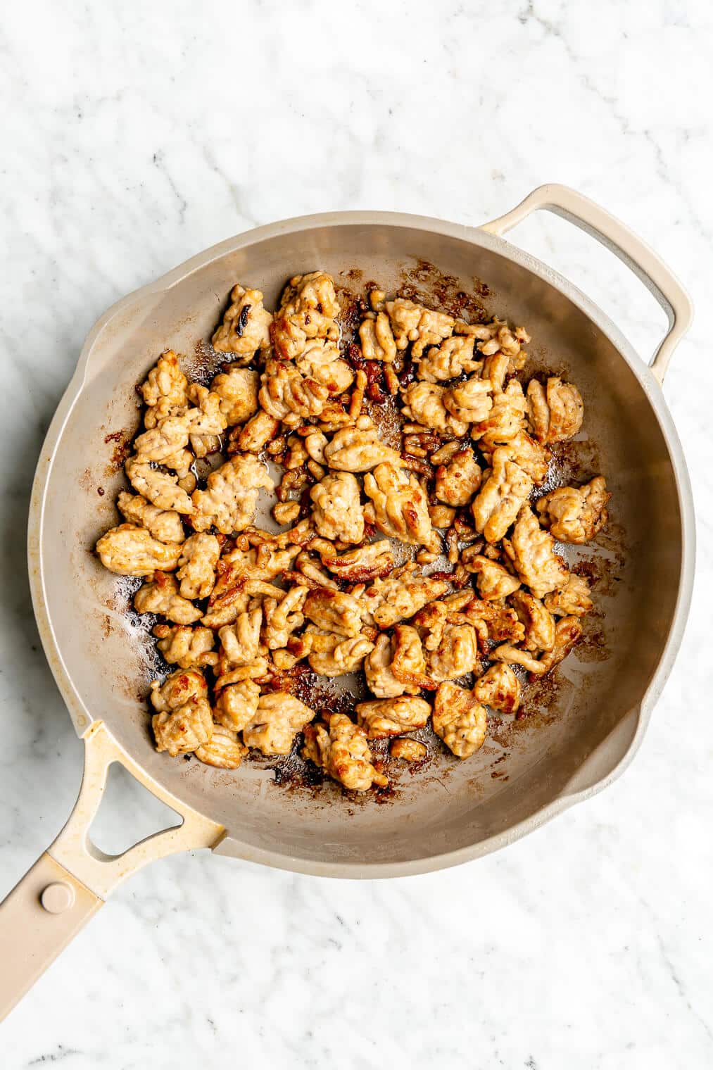 Italian sausage browned in a pan.