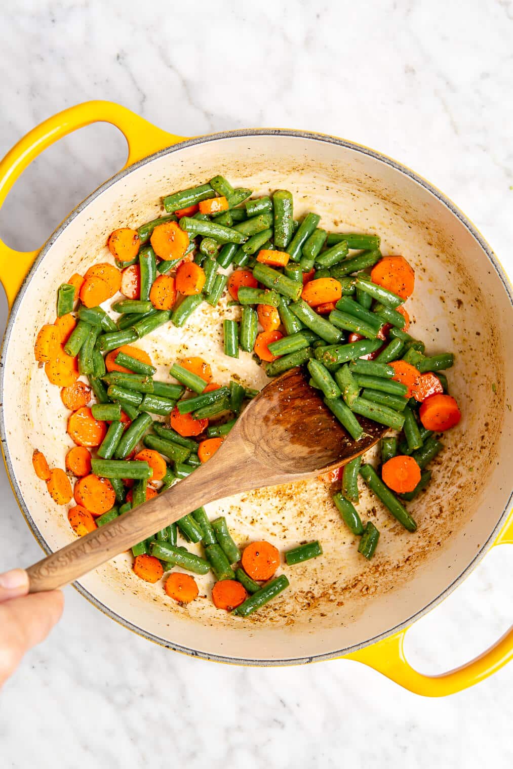 Sautéed green beans and carrots in an enameled dutch oven.