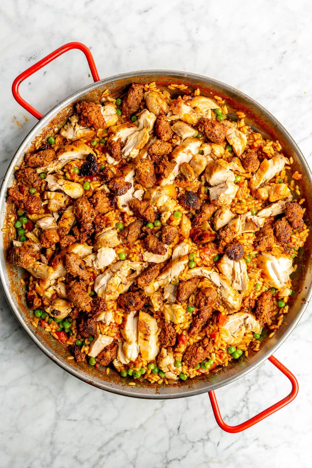 Chicken and chorizo paella in a large pan.