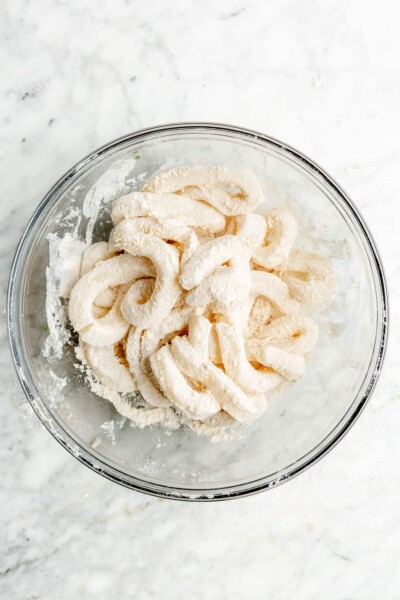 Raw calamari rings tossed in flour and salt before being cooked into crispy fried calamari.