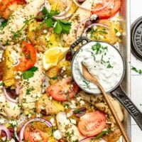 A close up of a Greek chicken sheet pan dinner.