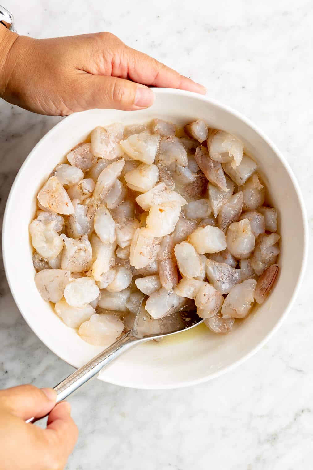 Chopped shrimp in a lime marinade for shrimp ceviche.