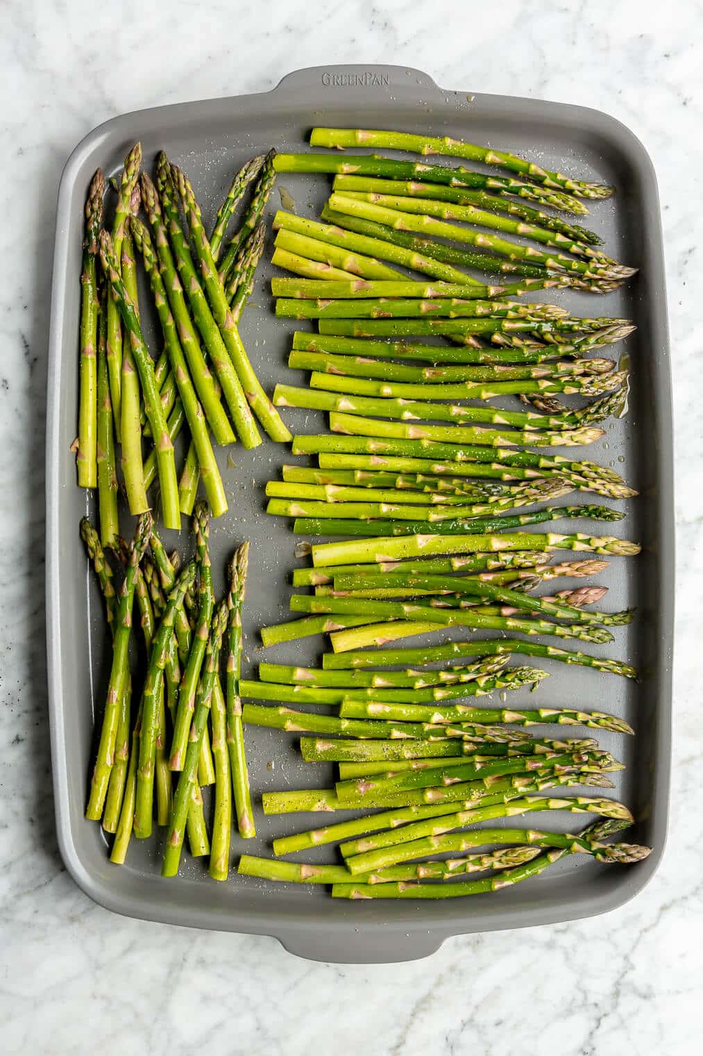 Raw asparagus on a sheet pan.