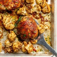 A sheet pan of balsamic chicken thighs and cauliflower.