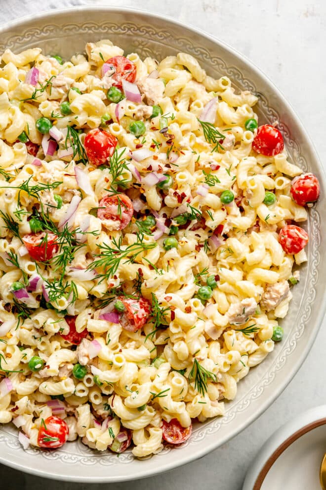 Top view of a large dish of creamy tuna pasta salad.
