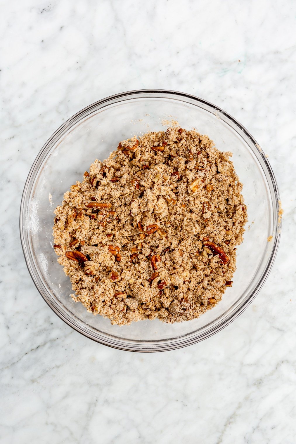 The crumble for strawberry rhubarb crisp in a large glass bowl.