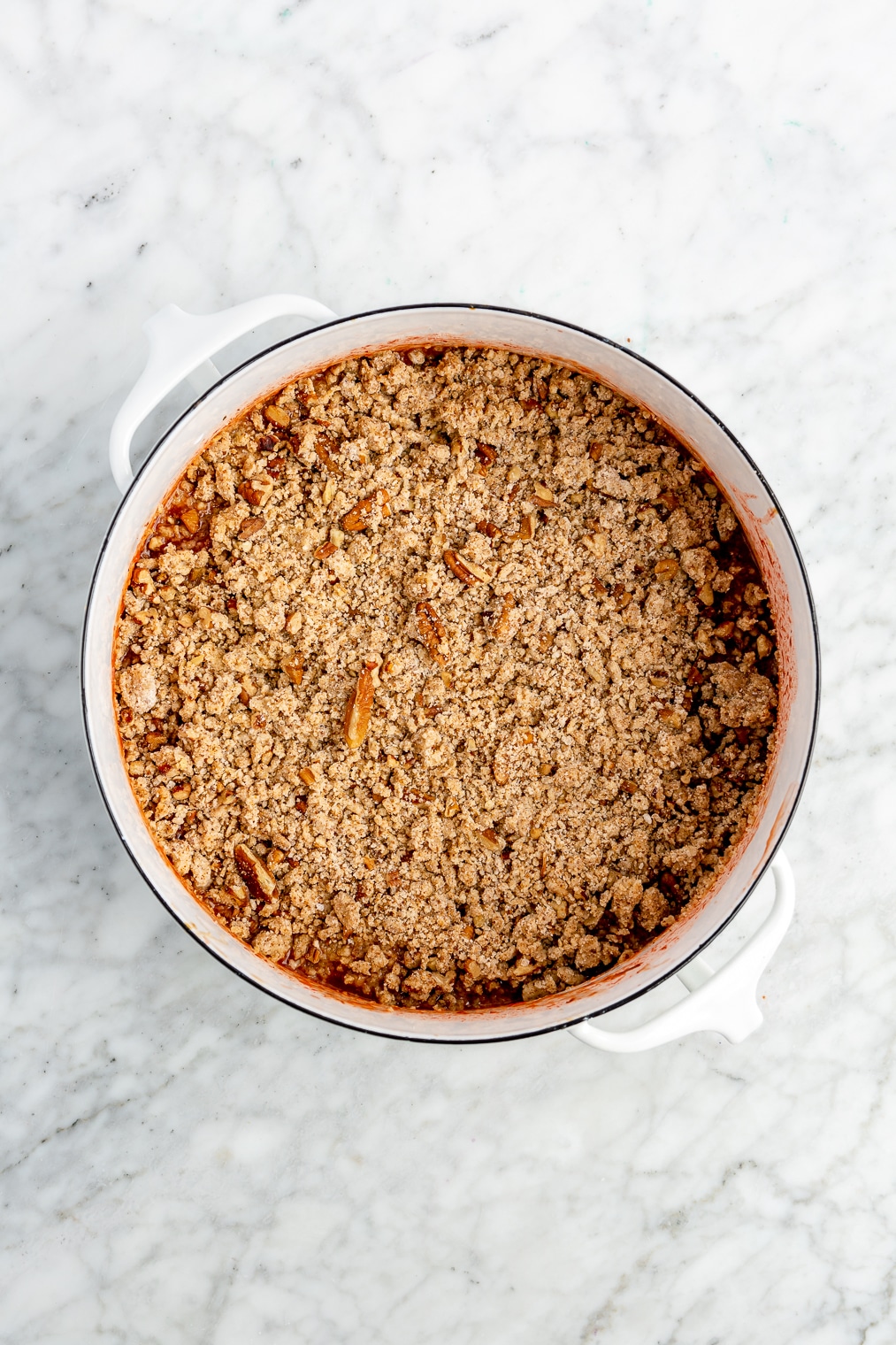 A strawberry rhubarb crisp before being baked in the oven.