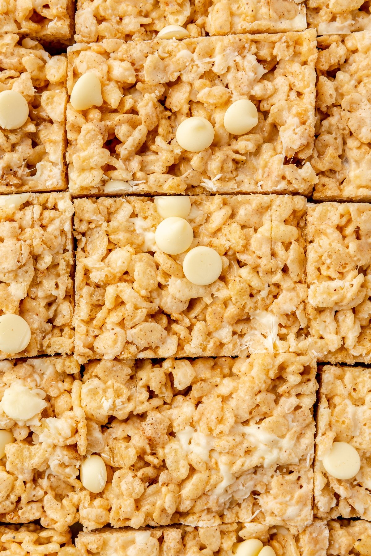 Sliced pumpkin spice rice crispy treats in a large baking dish.