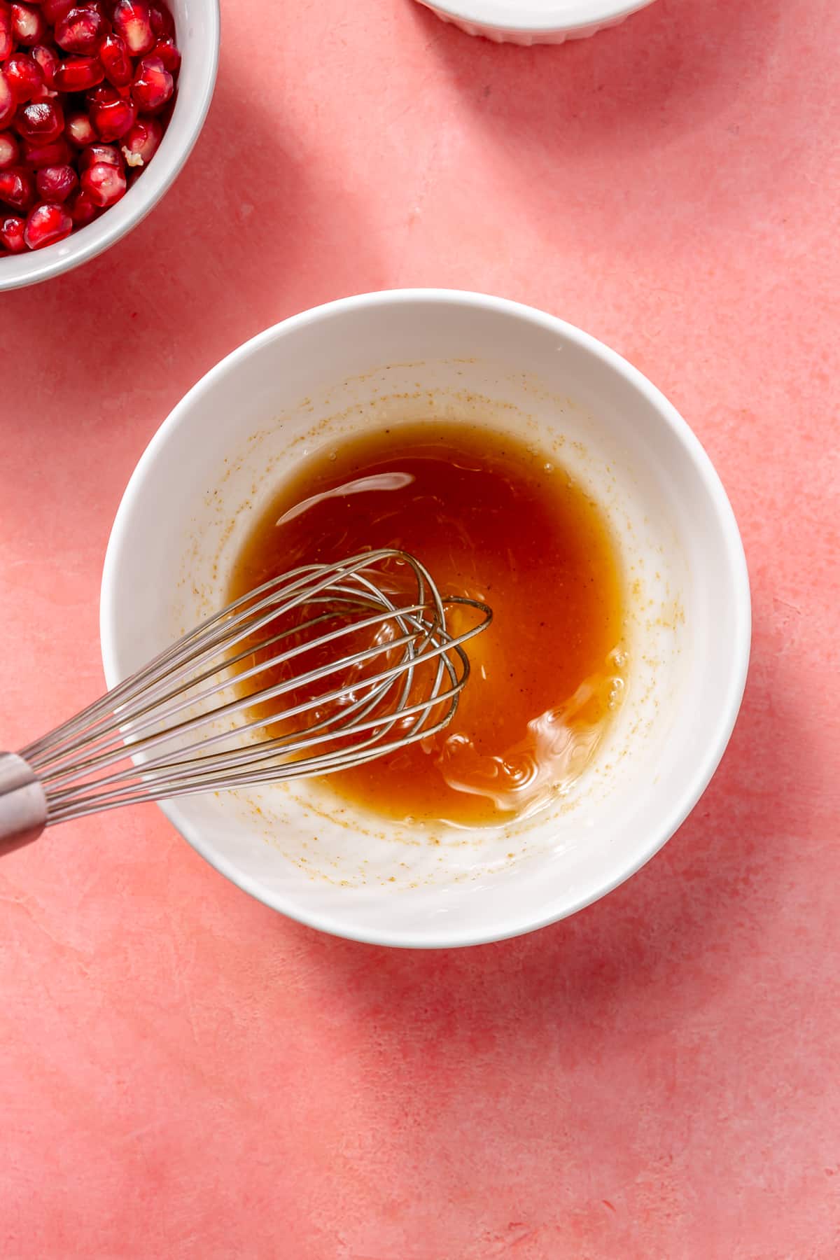 A whisk is shown mixing the golden-brown sauce.