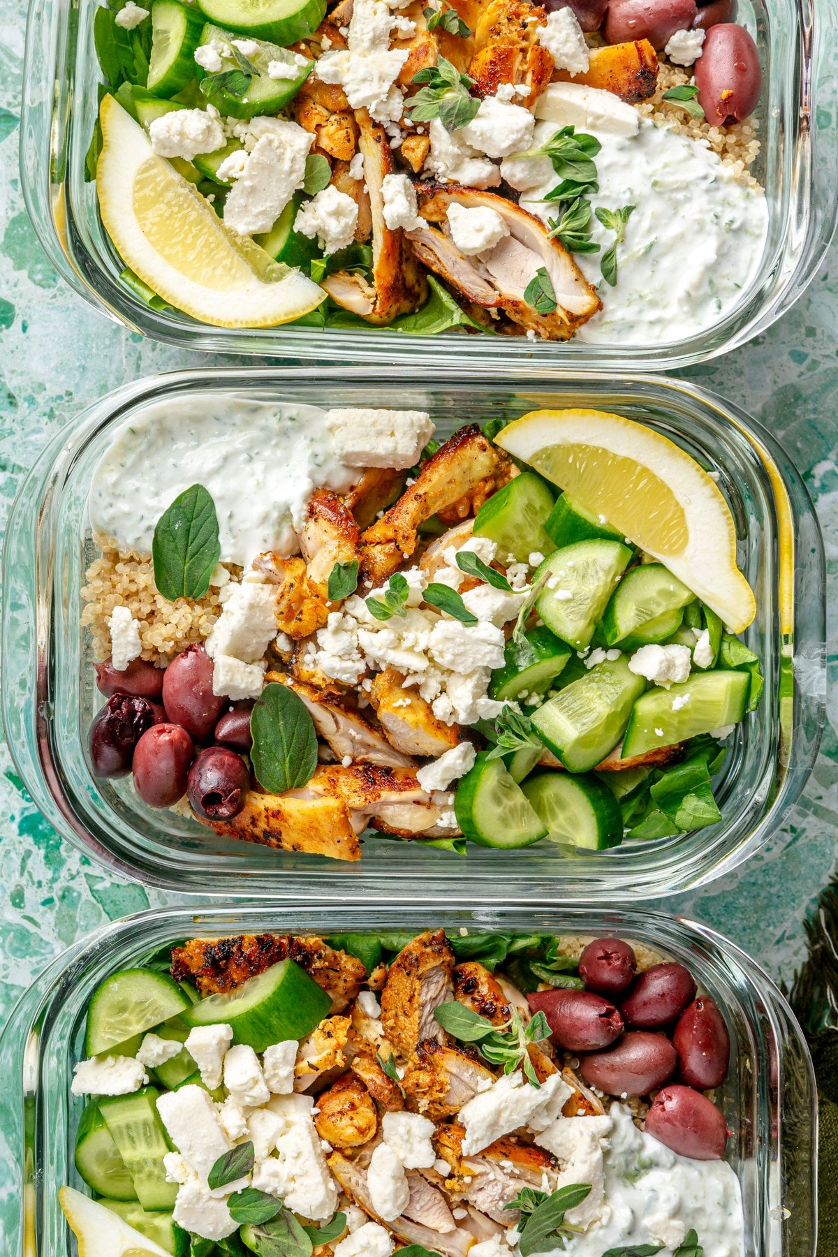 3 chicken gyro bowls in meal prep containers.