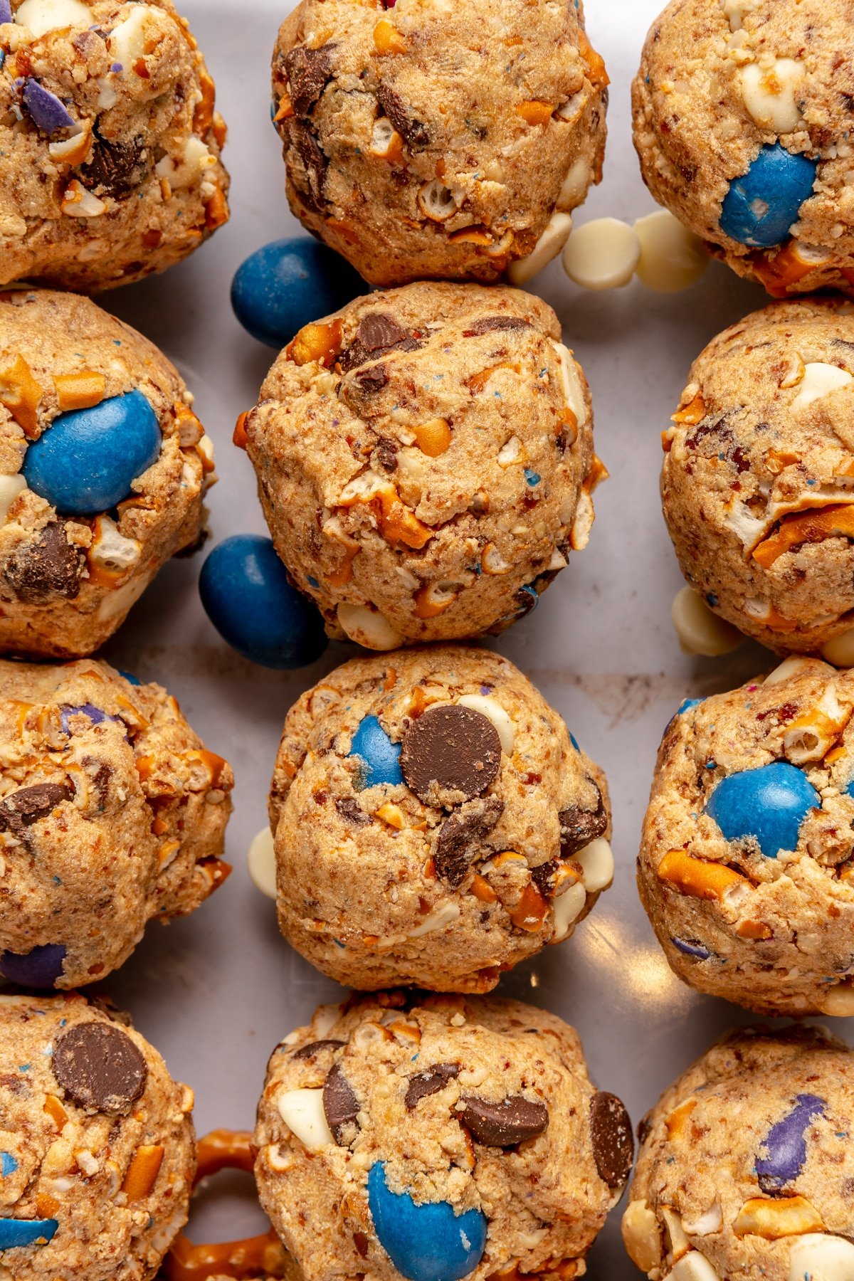 Kitchen Sink Energy balls loaded with pretzels, white and dark chocolate chips, and peanut M&Ms.