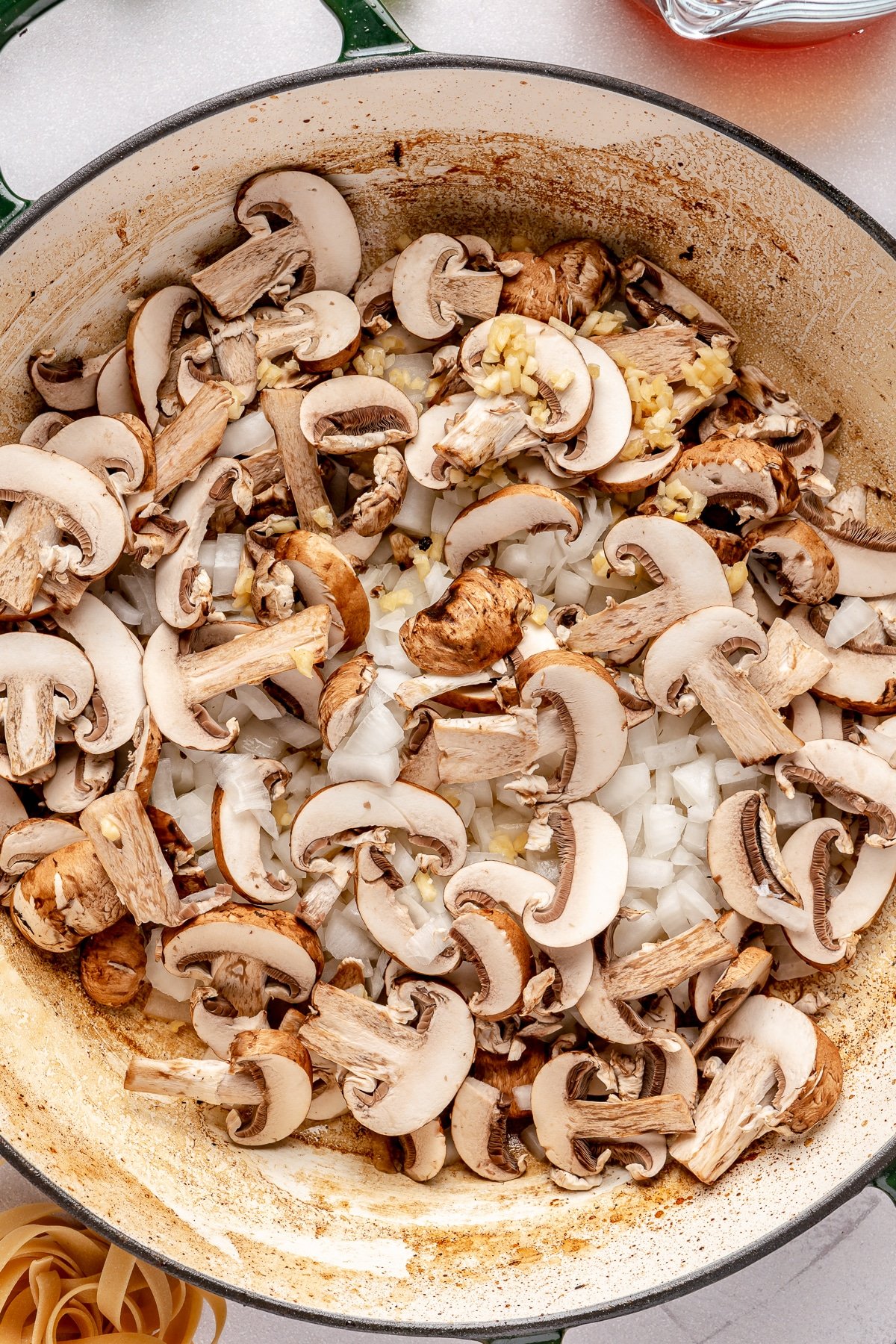 Mushrooms, garlic, and onions sauteing in a pan.